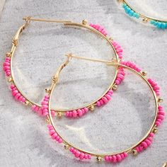 Bring a pop of fun and color into your outfit with these resort earrings! The hoops are gold in color and feature gold and colored beads. Available in Hot Pink and Teal Gold Beaded Hoop Earrings For The Beach, Gold Hoop Earrings With Colorful Beads For Beach, Gold Hoop Earrings With Tiny Beads For Summer, Pink Hoop Earrings With Colorful Beads For Beach, Beaded Pink Hoop Earrings For Beach, Pink Beaded Hoop Earrings For Beach, Summer Pink Hoop Earrings With Colorful Beads, Pink Beaded Small Hoop Earrings For Summer, Gold Beaded Small Hoop Earrings For Summer