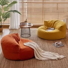 a living room with two bean bags on the floor and one chair in the middle