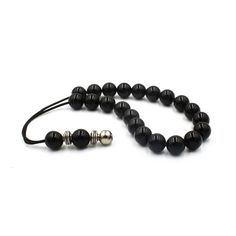 "Handcrafted Komboloi - Worry Beads created from 23 Black Onyx Beads in round shape. A pocket size set of worry beads which can be used for passing time and relaxation. Item can be made with different cord color. Please choose the cord color you would like from the drop down menu. Features: Item length: approx. 22cm / 9\" Bead size (approx.): 10mm / 0.39\" Bead type: Onyx Metal materials: Silver tone base alloy ☆ Here you can browsemore items in our shop: https://www.etsy.com/shop/sunnybeadsbyth Bohemian Black Bracelet With Polished Beads, Bohemian Black Bracelets With Polished Beads, Black Bohemian Bracelet With Polished Beads, Black Onyx 8mm Beads, Traditional Black Adjustable Beaded Bracelets, Black Onyx Gemstone Beads, Adjustable Black 8mm Beads, Hand-strung Black Bohemian Beads, Black Hand-strung Bohemian Beads