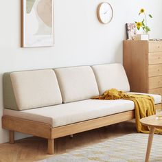 a white couch sitting next to a wooden table