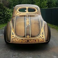 an old car is painted gold and black