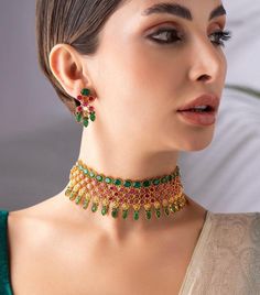 * Gold-Plated & Emerald Stone-Studded Jewellery Set * 22k Gold-Plated & emerald studded temple necklace secured with a drawstring closure * A pair of matching pair of earrings secured with a post-and-back closure *Size:- Necklace length: 18.6 cm Earrings length: 3.5 cm(each) *Material:- Material: Brass Plating: Gold-Plated NOTE All the raw material used in this product is of high quality and is handcrafted with love. Premium Quality and High craftsmanship 100% Satisfaction Guarantee: Long Lasting Plating, High-Quality Stones. Our jewellery is individually handcrafted by master artisans using meticulous crafting techniques. Resultantly, jewellery may have slight variations while retaining all aesthetics as reflecting in the product description. Such slight variation observed, if any, shall Ruby Choker Necklace Indian, Multicolor 22k Gold Bridal Necklace For Wedding, Green 22k Gold Temple Necklace For Wedding, Green 22k Gold Bridal Necklace For Wedding, Studded Jewellery, South Indian Necklace, Kemp Necklace, Indian Choker Necklace, Temple Jewelry