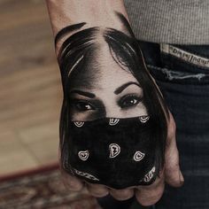 a woman's face painted on the palm of her hand