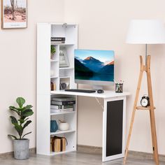 a desk with a computer on it and a lamp next to it in a room