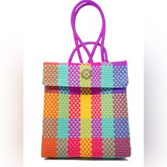 a multicolored handbag is displayed against a white background with the handle down