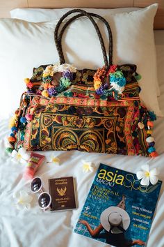 "This charming tote bag for lazy days at the beach and wandering around. It is made with an amazing piece of fabric woven by the HMONG hill tribes of Lanna Region (Northern Thailand). It features cotton lining, leather straps, a zipper closure and adorned with colorful hairs, pom poms. This bag will enhance your appearance. We buy materials from Hmong market and we design and sew by hand. Some of the bags we modify to improve the product. The Hmong tribes live in the North of Thailand and have o Bohemian Brown Bags For Beach Season, Bohemian Brown Beach Bag For Daily Use, Bohemian Hobo Bag For Beach Vacation, Bohemian Brown Beach Bag, Bohemian Pouch Bags For Vacation, Multicolor Hobo Tote Bag For Beach, Bohemian Tote Bag For Beach, Bohemian Rectangular Beach Bag For Beach Season, Bohemian Rectangular Shoulder Bag For Beach