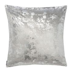 a silver pillow on a white background