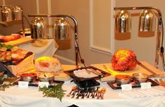 an assortment of food is displayed on a table with silverware and utensils