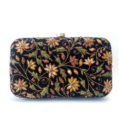 "Beautiful designer luxury black velvet hard case clutch bag, hand embroidered with a rich palette of caramel colored flowers and embellished with ruby gemstones. This will be your go to purse for any wedding! A classic design that never goes out of style. Expertly hand embroidered by third generation zardozi artisans. The word Zardozi means \"gold thread\". It is an elaborate and intricate multidimensional embroidery using metallic threads and genuine precious and semi precious gemstones. A cen Bride Purse, Velvet Clutch Bag, Embellished Purses, Clutch Purse Black, Floral Handbags, Floral Clutches, Velvet Clutch, Wedding Clutch, Party Purse