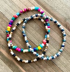 This personalized seed bead stretch cord bracelet comes in many different colors.  They are so cute!  Simply message me with the color or colors that you would like.  I have many other colors for you to create a custom bracelet as well.  This listing highlights most of them.  I am able to make the bracelets in size 6 1/2, 7, and 7 1/2.  This would be a great bracelet to stack with other bracelets.  They would also make a great gift!  There are lovely hoop earrings in my shop too that would look great with the bracelest!  Please remember to message me with the colors you would like.   ~I use high quality hypoallergenic materials along with many different colors and types of beads.  I work hard to create beautiful pieces and to provide excellent customer service.   Packaging All of my bracel Bohemian Turquoise Stretch Bracelet With Heishi Beads, Bohemian Turquoise Heishi Beads Stretch Bracelet, Adjustable Multicolor Beaded Bracelets With Letter Beads, Hand-strung Multicolor Bracelets For Friendship, Multicolor Beaded Friendship Wrap Bracelet, Adjustable Multicolor Casual Beads, Multicolor Heishi Beads Friendship Bracelets, Colorful Adjustable Hand-strung Friendship Bracelets, Multicolor Round Beads Wrap Bracelet For Friendship