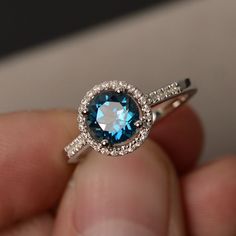 This is a gorgeous handmade creation. Its beauty is its simplicity & Elegance. The 7*7mm round cut London blue topaz is crafted in solid sterling silver and with rhodium plated. All item is sent in a beautiful gift box You can realize more lovely stuff clicking the link https://www.etsy.com/shop/knightjewelry?refshopsection_shophome_leftnav Please leave the correct address and you phone number for delivering successfully. Sapphire Topaz Round Ring For Promise, Sapphire Topaz Promise Ring, Sapphire Topaz Ring For Promise, Blue Topaz Ring With Halo Design, Round Sterling Silver Topaz Ring For Anniversary, Fine Jewelry Blue Topaz Ring With Halo Design, Sterling Silver Round Topaz Ring For Anniversary, Sterling Silver Topaz Ring With Halo Design For Promise, Blue Topaz Round Promise Ring