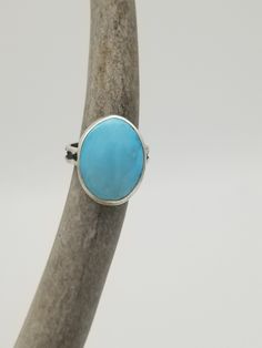 "Blue Bird Turquoise is so beautiful and is unique in that it is one of the few turquoise mines that produces this \"Robin's Egg\" blue. This stone was cut and polished by me. (Natural) Located west of Globe, Arizona and near Copper Creek, this mine has little info on it. Every ring is one of a kind. This turquoise is exceptional! This color, with no matrix is rare. Size 8 Very unique, handmade artisan piece of jewelry in .925 sterling silver." Adjustable Blue Larimar Ring, Blue Larimar Round Rings, Adjustable Untreated Blue Turquoise Ring, Blue Larimar Cabochon Rings, Blue Larimar Opal Ring, Unique Turquoise Larimar Ring, Unique Turquoise Larimar Gemstone Ring, Turquoise Oval Cabochon Gemstone Ring, Turquoise Gemstone Rings With Oval Cabochon