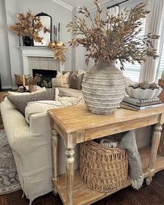 a living room filled with furniture and a large potted plant on top of a table