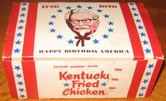 an old kentucky fried chicken box on a wooden table with red, white and blue stars