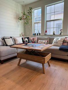 a living room with two couches and a coffee table in front of the window