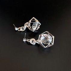 Unusual, sparkly diamond shaped crystals are captured in silver plated cages. I have joined them to the crystal, non allergenic, stainless steel posts with chain maille. Nice neutral earrings will go with anything. Makes a lovely gift. Here is a link to my whole shop: https://www.etsy.com/shop/designsbymalone RETURNS - BUY WITH CONFIDENCE Don't worry, I will refund or exchange an item up to 60 days. Makes gift giving easy! All my items will arrive in a gift box and/or a velvet or organza pouch. Crystal Evening Earrings, Silver Sparkling Crystal Earrings For Gift, Party Earrings With Clear Metal, Silver Crystal Earrings With Sparkling Stones For Gift, Silver Drop Earrings For Party, Party Crystal Earrings For Pierced Ears, Party Clear Crystal Earrings For Pierced Ears, Silver Crystal Dangle Earrings With Sparkling Stones, Silver Cubic Zirconia Crystal Earrings Nickel Free