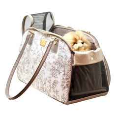 a small dog is sitting in a pet carrier with its head sticking out from it's side