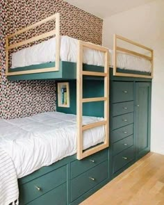 two bunk beds are next to each other in a room with wooden floors and wallpaper