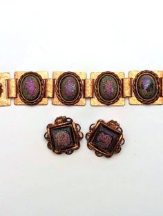 Mid-Century bracelet and clip earring set. Shimmering painted plastic gems set in copper. From the 1970's.  The set is in good vintage condition. The bracelet measures about 7 inch by 1 inch and the earrings measure about 1 1/8 inch by 1 1/8 inch. Please visit our Etsy store for similar items at http://www.etsy.com/shop/MarleysOnMain As with all vintage and antique jewelry, this is a previously used piece and will show some signs of wear. Please review our shop policies. Bracelet And Earring Set, Clip Earring, Painting Plastic, Bay City, Plastic Jewelry, Arm Band, Fashion Earrings, Antique Jewelry, Clip On Earrings