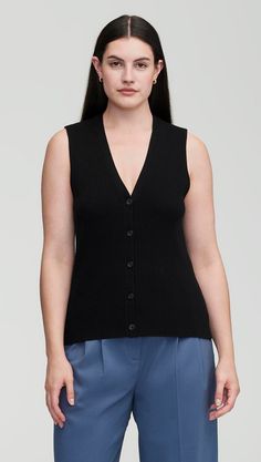 Elevate your workwear with a classic knit rib waistcoat. Designed to be worn as a top on its own or styled over a shirt or blouse, our waistcoat reimagines traditional suiting for the modern working woman. The slim silhouette features an all over ribbed pattern, a fitted v-neck silhouette, and button closure. Wear with relaxed trousers and sneakers for a cozy yet put-together ensemble. V-neck Knit Vest For Work, Classic Sweater Vest With Button Closure For Work, Chic Knit Sweater Vest For Work, V-neck Sweater Vest With Button Closure For Work, Classic Sweater Vest For Workwear In Spring, Classic Black Sweater Vest For Spring, Classic Business Casual Vest Top, Black Knit Sweater Vest For Work, Elegant Knit Vest For Workwear