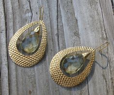 "A bohemian chic inspired handcrafted masterpiece in solid 18k Gold Large Hoop Earrings accented with Lemon Quartz. The earrings are hand carved giving way to a beautiful intricate texture, further accented with Lemon Quartz makes a timeless classic jewel. (e-124) Lemon Quartz(6.85cts) 11.5mm x 16.5mm Gold weight 15grams Drop length 2.5\" *Follow us @belesasjewelry on Instagram for promotions/giveaways *LIKE* us on Facebook http://www.facebook.com/Belesas *If you like the ring, please click on t Handmade Gold Briolette Teardrop Earrings, Gold Briolette Teardrop Handmade Earrings, Gold Bohemian Earrings With Gemstone Accents, Luxury Gold Hoop Earrings With Gemstone, Luxury Gold Gemstone Hoop Earrings, Bohemian Teardrop Yellow Gold Earrings, Bohemian Yellow Gold Teardrop Earrings, Modern Gold Earrings With Gemstone Accents, Gold Teardrop Earrings With Gemstone Accents