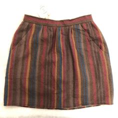 Urban Renewal Nwt Vintage Skirt Size 7/8 100% Virgin Wool One Of A Kind. Skirt Is Reworked Vintage And Recycled Pieces, Deadstock Fabric, Eco-Fabrics And One-Of-A-Kind Finds. Please See Measurements In Photographs Skirt Is Brown With Stripes Colors Of Purple Rust Maroon And Tan. The Skirt Is Fully Lined And Has A Zipper Button Closure In Back. The Skirt Is Vintage And Reworked By Urban Renewal Original Brand Name Is Patty Woodard California. Condition: Nwt Closet Item: B 45 Casual Multicolor Skirt With Pockets, Retro Brown Skirt With Pockets, Brown Mini Skirt With Pockets, Brown Cotton Mini Skirt, Brown Relaxed Skirt With Elastic Waistband, Casual Brown Lined Skirt, Brown Pencil Skirt With Pockets, Brown Casual Midi Skirt, Casual Brown Midi Skirt