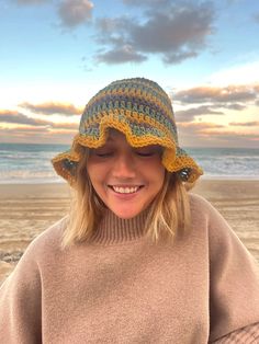 a woman wearing a knitted hat on the beach