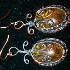 Created Amber Gemstones In Wire Wrapped Design Pierced Earrings" ...These Awesome Amber Gemstone Earrings Are Hand Wrapped Wire Around The Gemstone. The Wiring Throughout Is Done In More Than 1 Type Of Wire Finishes From A Copper To A Darker Finish. They Dangle To 2-1/2" And Are For Pierced Ears Only! This Seller Really Loves The Color Combinations On The Wire And The Lab Created Amber Stone. You Can See Inclusions In The Amber Making Them More Interesting If You Can Figure Out What's Inside! Th Handmade Yellow Metal Earrings, Handmade Oval Yellow Jewelry, Handmade Yellow Oval Jewelry, Handmade Yellow Copper Jewelry, Unique Yellow Teardrop Jewelry, Elegant Yellow Wire Wrapped Earrings, Yellow Wire Wrapped Drop Earrings, Unique Yellow Nickel-free Jewelry, Unique Yellow Wire Wrapped Jewelry