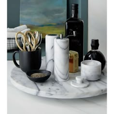 an assortment of kitchen utensils on a marble tray