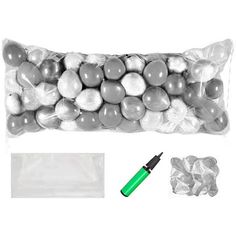 a bag filled with lots of white and silver candies next to a green marker