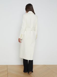 Classic meets chic in our Olina belted long coat, perfectly crafted from a premium wool sustainably produced by Manteco in Tuscany, Italy.• Manteco wool-blend fabric• Fully lined• Double-breasted front closure with tie belt• Flap pockets• Embossed dome buttons• Back hem vent | L'AGENCE Olina Coat In Ivory Luxury Cream Outerwear With Double Button Closure, Luxury Wool Coat With Belted Cuffs For Office, Luxury Cream Double-breasted Outerwear, Luxury Belted Wool Coat With Notch Lapel, Luxury Belted Wool Coat For Formal Occasions, Elegant Cream Wool Coat With Notch Lapel, Elegant Cream Wool Coat For Business, Elegant Cream Outerwear With Belted Cuffs, Luxury Belted Wool Coat For Office