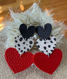 three heart shaped earrings with black, white and red polka dots on each earring