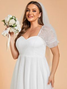 a woman in a white wedding dress holding a bridal bouquet