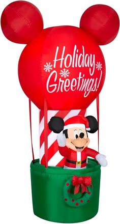 mickey mouse balloon with the words holiday greetings on it's head and ears