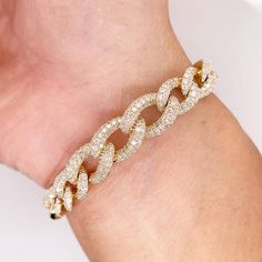 This gorgeous Miami Cuban diamond enhanced bracelet is perfect for every occasion. The beautiful 2.72 carats are delicately set in 14 karat yellow gold giving a new and original take on the classic Miami Cuban. Metal Quality: 14K Yellow GoldLength: 7.20inWidth: 7.7 - 10.1mmClasp: Hidden Link ClaspDiamond Shape: Round BrilliantDiamond Weight: 2.72ctDiamond Clarity: VS2 (Excellent, Eye Clean)Diamond Color: G (Excellent, Near Colorless)Total Weight: 2.72ct Elegant White Gold Cuban Link Diamond Bracelet, Elegant White Gold Cuban Link Bracelet With Cubic Zirconia, Dazzling Cubic Zirconia Diamond Bracelet With Pave Setting, Elegant Diamond Cuban Link Tennis Bracelet, Elegant Cuban Link Diamond Bracelet With Diamond Cut, Elegant Diamond-cut Cuban Link Diamond Bracelet, Elegant Cuban Link Diamond Tennis Bracelet, Classic Diamond Cuban Link Bracelet, Elegant Diamond Bracelet With Cuban Link