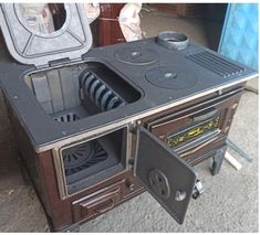 an old fashioned stove with its door open