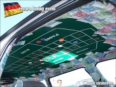 the interior of a car decorated with paper money and games on it's windshield