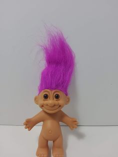 a troll doll with purple hair on it's head