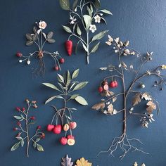 the wall is decorated with different types of flowers and leaves