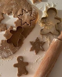 cookies and cookie cutters on a white surface