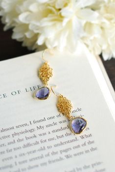 "Purple and Gold Earrings. Stunning faceted purple glass stones are suspended from beautiful matte gold ornate filigree connectors and gold plated hook ear wires. The total length of these earrings is approx. 1.8\" (46mm). Purple glass measures 12mmx 17mm If you prefer the glass stones in a different color, please feel free to contact me. ♥ Click here to see more earrings: www.etsy.com/shop/LeChaim?section_id=17655958 ♥ My shop: www.etsy.com/shop/LeChaim ♥ About LeChaim: www.etsy.com/shop/LeChai Purple Crystal Earrings For Wedding, Elegant Purple Jewelry With Ear Wire, Elegant Lavender Crystal Earrings For Party, Elegant Purple Dangle Chandelier Earrings, Wedding Gemstone Drop Chandelier Earrings, Elegant Purple Gemstone Chandelier Earrings, Elegant Lavender Earrings With Ear Wire, Teardrop Faceted Crystal Earrings For Weddings, Elegant Faceted Chandelier Earrings For Gifts