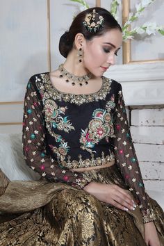 Choli: Pure raw silk choli, chiffon sleeves, featuring antique gold dabka, sequins, beads, stones, pearls and multi colored silk thread embroidery.Choli Color: BlackLehnga: Pure atlas jamawar Lehnga finished with golden border.Lehnga Color: Black and antique GoldDupatta: Pure Crushed maysuri dupatta featuring sequin motifs and sprinkles all over finished with gota.Dupatta Color: Antique Gold This is a made to measure look, once order is placed design team will get in touch with you regarding mea Jamawar Lehnga, Silk Thread Embroidery, Sana Javed, Golden Border, Chiffon Sleeves, Designer Outfit, Pakistani Designers, Thread Embroidery, Silk Thread