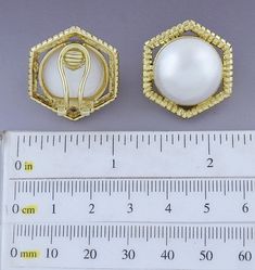 Presented is a lovely pair of 18 karat gold and pearl earrings. These are relatively modern earrings, likely made in Italy or elsewhere in Europe. The earrings are done in a hexagonal style, each set with a beautiful mabe pearl of about 18.5 millimeters in diameter. The gold settings are heavy and high quality, done in a ribbed design. The earrings have omega style clipbacks for wear with unpierced or pierced ears, but a jeweler could easily add posts so the earrings could be worn specifically f Elegant Octagon Earrings For Formal Occasions, Elegant White Octagon Earrings, Luxury Gold Octagon Earrings, Elegant Octagon Wedding Earrings, Gold Octagon Earrings For Wedding, Gold Octagon Wedding Earrings, Elegant White Hexagon Jewelry, Elegant Hexagon Earrings For Gift, Elegant Gold Hexagon Jewelry