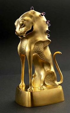 a golden lion statue sitting on top of a table