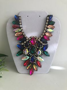 "Beautiful  multicolor statement  necklace  shine and bright for any special occasional  Necklace statement 5.5\" wide. 8\" height with 30\" extender Closure: ribbon tie Adjustable length  Return & exchanges We gladly accept cancellations Request a cancellation within 4 hour of purchase.  We don't accept return or exchanges but please contact us if You have any questions or any problem with your orders Thank you for shopping with us ♥️ Stay safe & healthy" Luxury Multicolor Necklace With Large Beads, Affordable Multicolor Long Necklace, Colorful Costume Jewelry Necklaces For Party, Multicolor Rhinestone Costume Necklace, Multicolor Costume Jewelry Bib Necklace For Party, Multicolor Rhinestone Necklace For Party, Multicolor Rhinestone Costume Necklace For Parties, Oversized Necklace, Bold Statement Necklaces