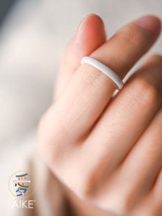 a woman's hand with a wedding ring on her finger, close up view