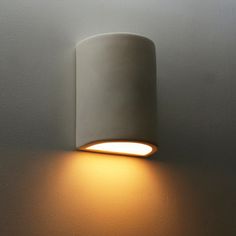 a white wall light with a dimmer on it's side next to a gray wall