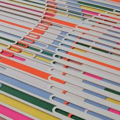 many different colored paper straws are stacked on top of each other in order to form a pattern