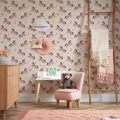 a child's room with pink chairs and wallpaper