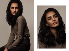 a woman with long black hair sitting on a stool and posing for the camera, wearing a brown sweater